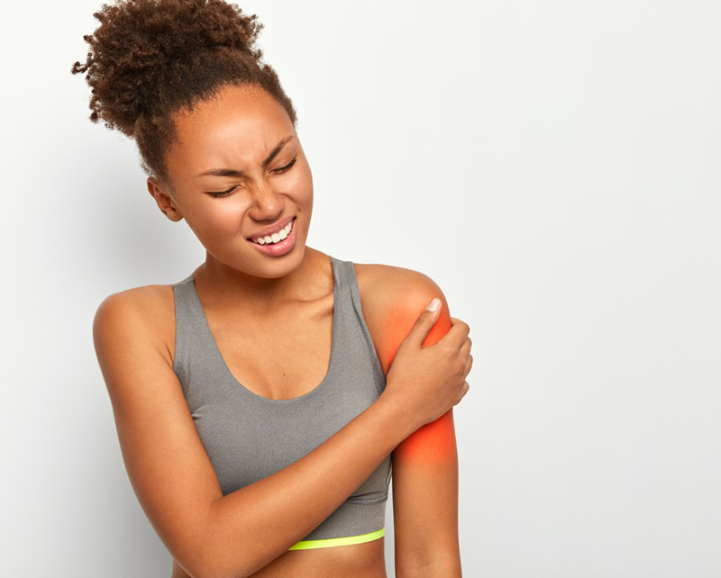 Physical therapist assisting patient with arm rehabilitation